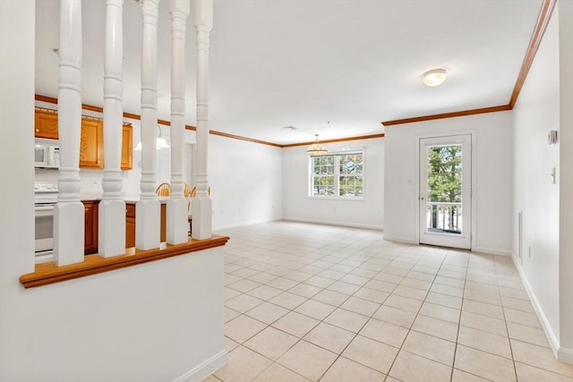 spare room featuring ornamental molding, baseboards, and light tile patterned flooring