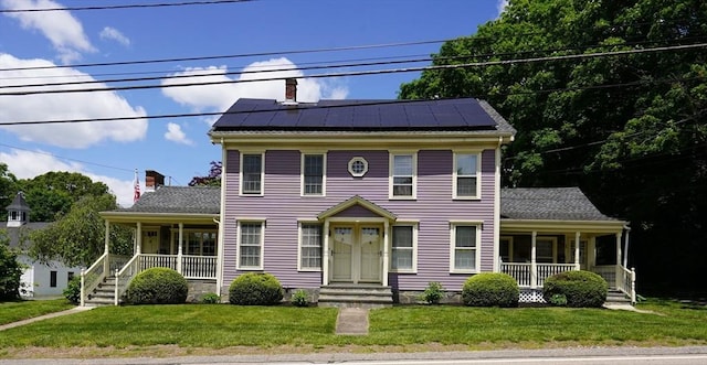 56-58 E Bacon St, Plainville, MA 02762 - colonial home featuring a porch, solar panels, and a front yard