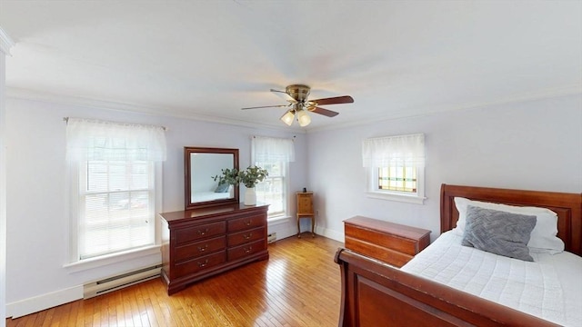 56-58 E Bacon St, Plainville, MA 02762 - bedroom featuring a baseboard radiator, light wood-type flooring, crown molding, baseboards, and a ceiling fan