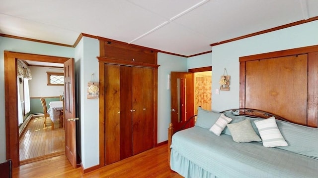 56-58 E Bacon St, Plainville, MA 02762 - bedroom with light wood-type flooring, crown molding, and a closet