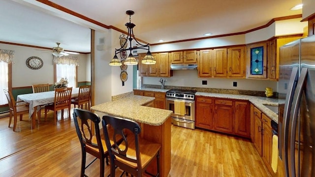 56-58 E Bacon St, Plainville, MA 02762 - kitchen featuring appliances with stainless steel finishes, under cabinet range hood, a peninsula, brown cabinets, and crown molding