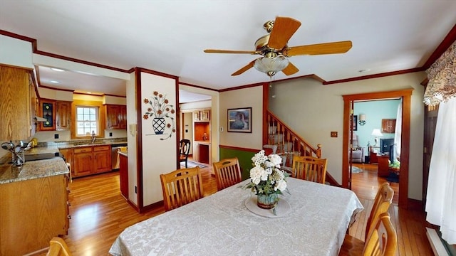 56-58 E Bacon St, Plainville, MA 02762 - dining area featuring ceiling fan, light wood-style floors, crown molding, stairs, and a baseboard heating unit