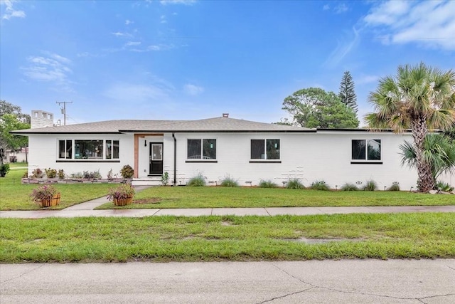 single story home featuring a front lawn