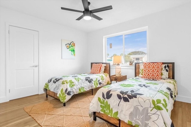 bedroom with ceiling fan and light hardwood / wood-style flooring