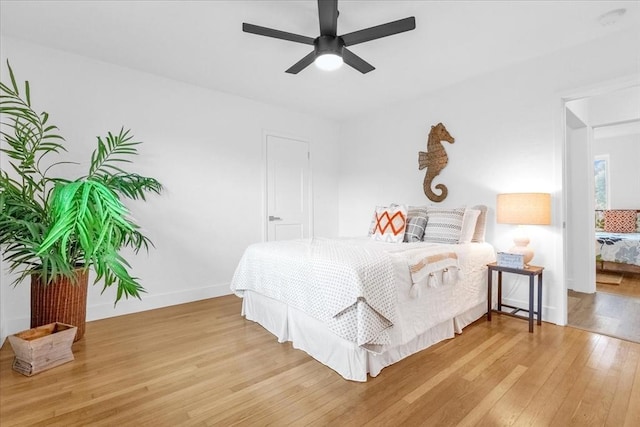 bedroom with ceiling fan and light hardwood / wood-style flooring