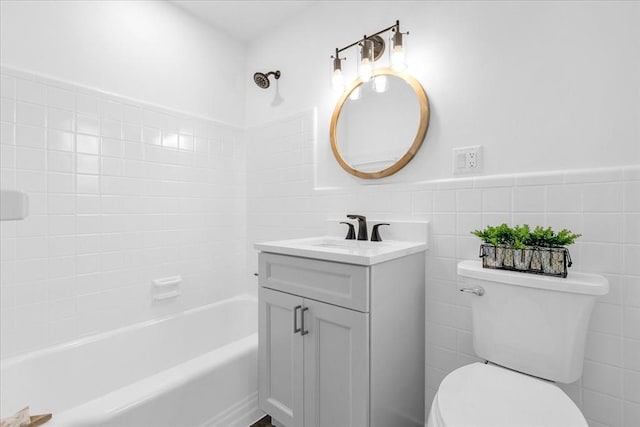 full bathroom featuring shower / bathtub combination, vanity, toilet, and tile walls