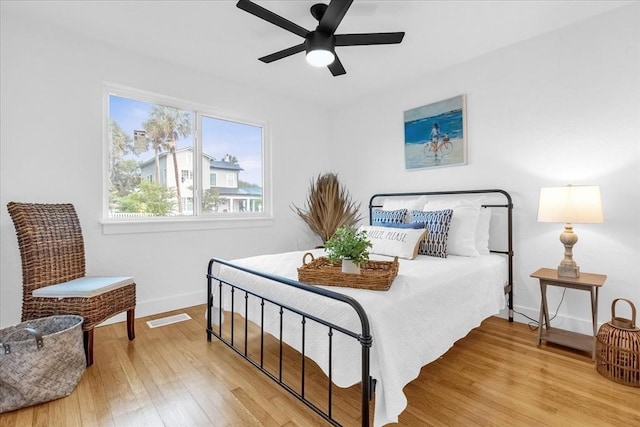 bedroom with ceiling fan and light wood-type flooring