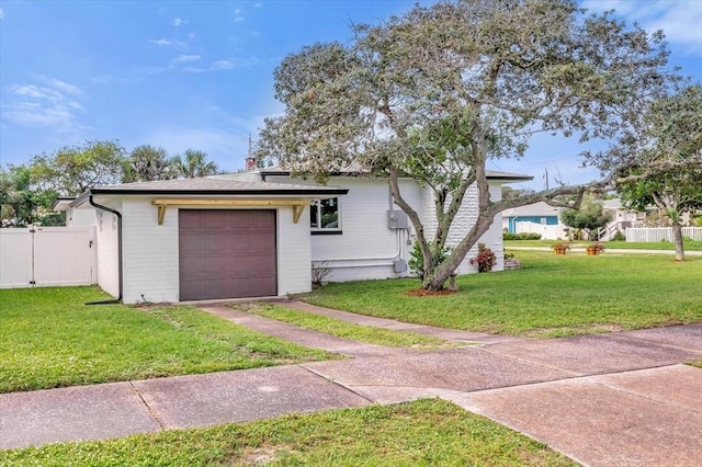 view of front of property featuring a garage and a front lawn