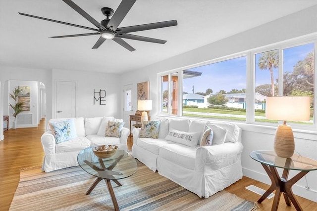 living room featuring ceiling fan and light wood-type flooring