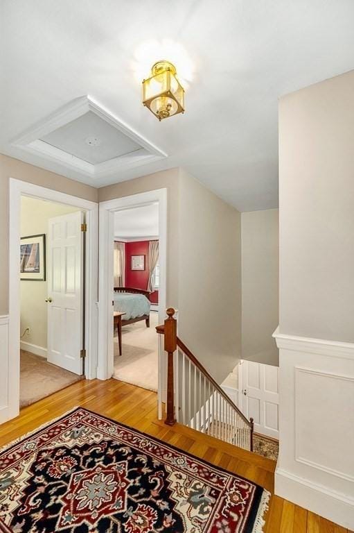 3 Tally Ho Dr, Hamilton, MA 01982 - hallway with light wood-type flooring, an upstairs landing, wainscoting, and a decorative wall