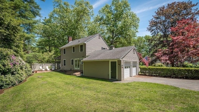 3 Tally Ho Dr, Hamilton, MA 01982 - back of house featuring a chimney, a shingled roof, and a detached garage