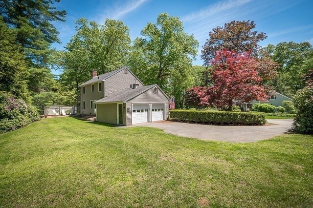 3 Tally Ho Dr, Hamilton, MA 01982 - view of home's exterior with an attached garage, a chimney, a lawn, and concrete driveway