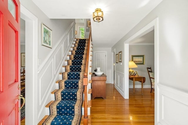 3 Tally Ho Dr, Hamilton, MA 01982 - foyer featuring light wood-style floors, stairway, a decorative wall, and a wainscoted wall
