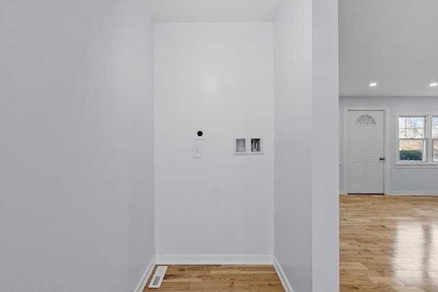 washroom with electric dryer hookup, visible vents, baseboards, recessed lighting, and light wood-style flooring