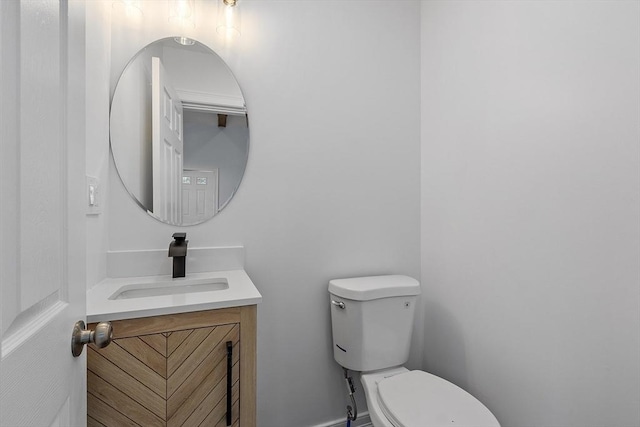 half bathroom with vanity and toilet