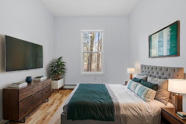 bedroom featuring a baseboard radiator and light wood-style flooring