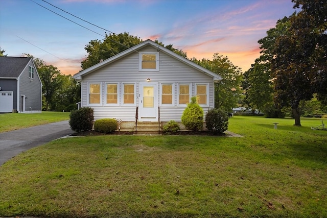 bungalow-style home with a lawn