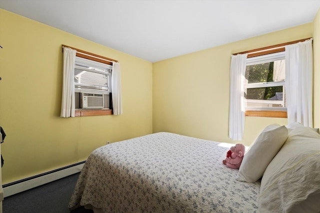 carpeted bedroom with a baseboard heating unit and cooling unit