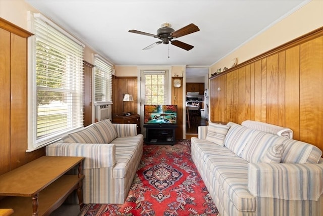 living room with ceiling fan and crown molding