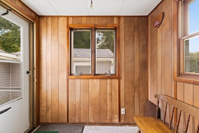 doorway featuring wooden walls