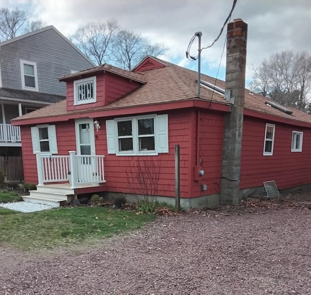 bungalow featuring a shingled roof