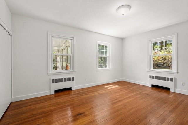 39 Manton Rd, Swampscott, MA 01907 - spare room featuring radiator, hardwood / wood-style flooring, and baseboards