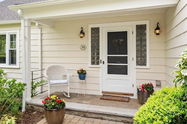 39 Manton Rd, Swampscott, MA 01907 - property entrance with covered porch and roof with shingles