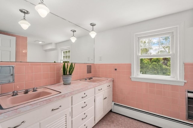 39 Manton Rd, Swampscott, MA 01907 - bathroom with baseboard heating, tile walls, double vanity, and a wainscoted wall