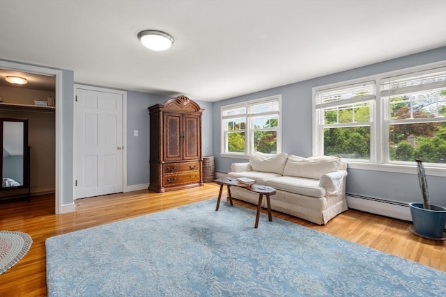 39 Manton Rd, Swampscott, MA 01907 - living room with a baseboard heating unit, light wood-type flooring, and baseboards