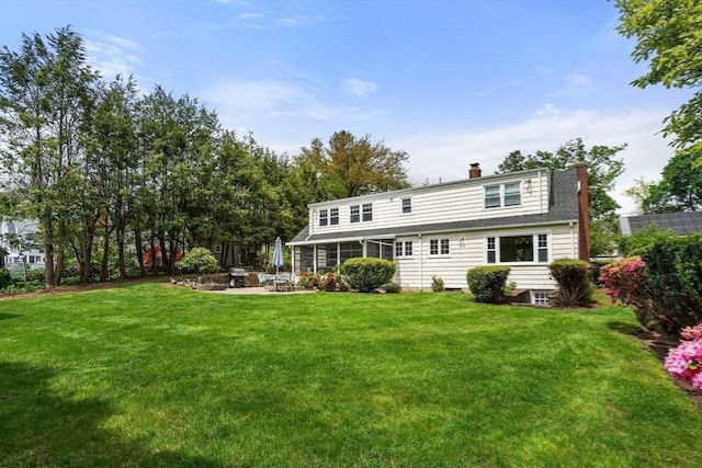 39 Manton Rd, Swampscott, MA 01907 - rear view of property featuring a chimney, a patio, a lawn, and a fire pit