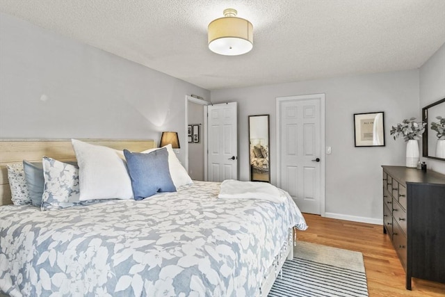 188 Munger Hill Rd, Westfield, MA 01085 - bedroom with light wood-style floors, baseboards, and a textured ceiling