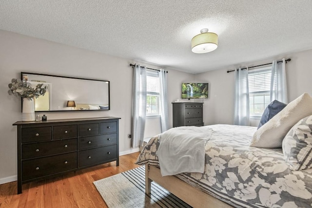 188 Munger Hill Rd, Westfield, MA 01085 - bedroom featuring multiple windows, light wood-type flooring, baseboards, and a textured ceiling