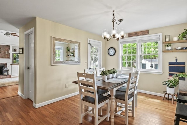 188 Munger Hill Rd, Westfield, MA 01085 - dining room with ceiling fan, a chandelier, wood finished floors, baseboards, and a fireplace