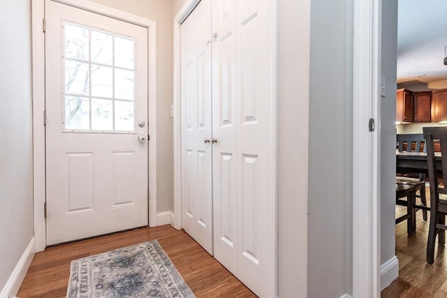 doorway to outside featuring a healthy amount of sunlight and light wood-type flooring