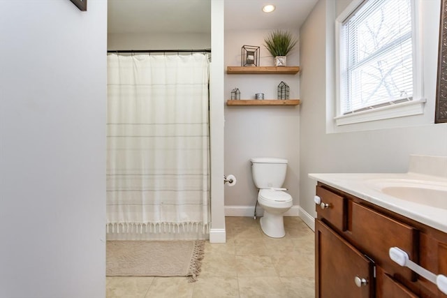 bathroom featuring toilet, tile patterned flooring, vanity, and curtained shower