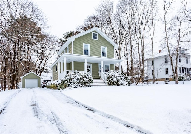 view of front of property featuring a garage, a porch, and an outdoor structure