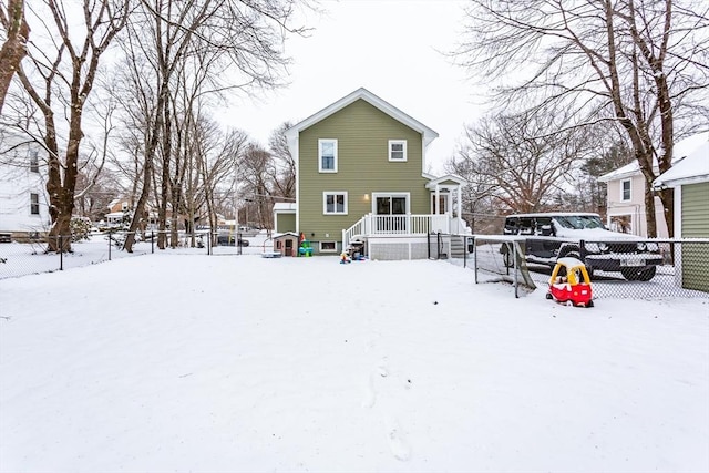 view of snow covered rear of property