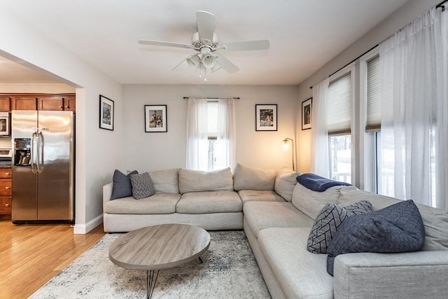 living room featuring ceiling fan and hardwood / wood-style floors