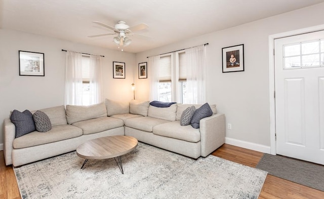 living room with ceiling fan, plenty of natural light, and hardwood / wood-style flooring