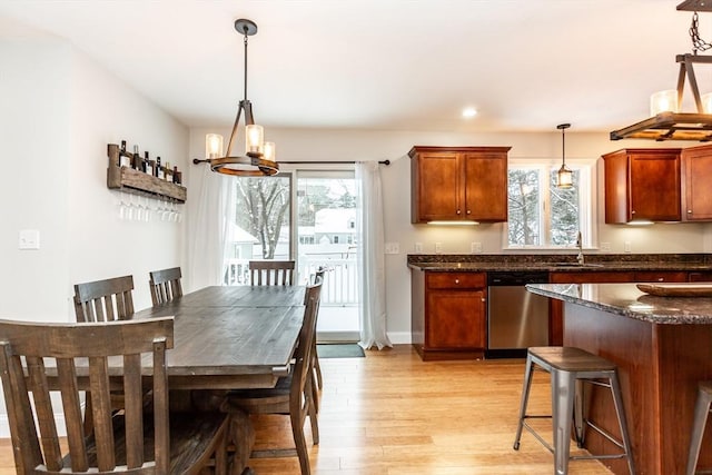 dining space with light hardwood / wood-style floors and sink