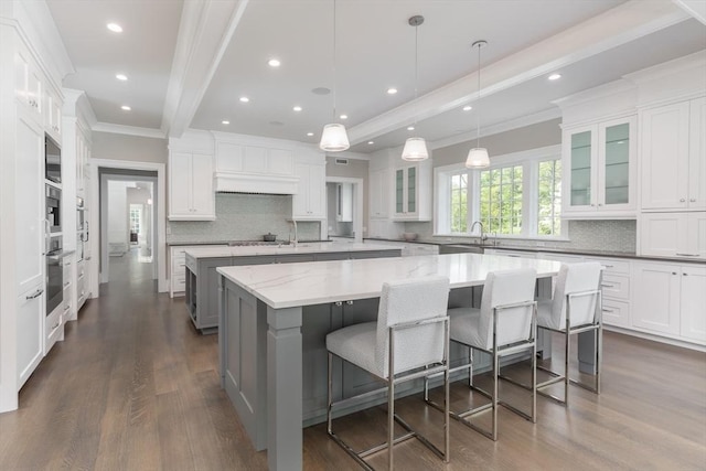 8 Hidden Rd, Weston, MA 02493 - kitchen with a spacious island, crown molding, dark wood-style floors, tasteful backsplash, and recessed lighting