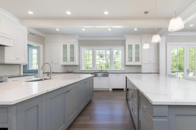 8 Hidden Rd, Weston, MA 02493 - kitchen with a large island with sink, a sink, gray cabinets, ornamental molding, and recessed lighting