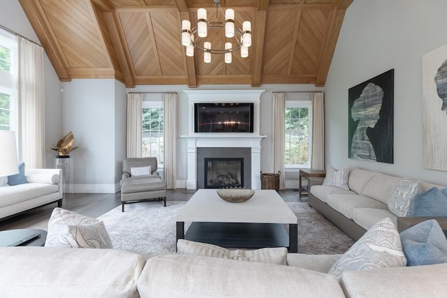 8 Hidden Rd, Weston, MA 02493 - living room featuring a chandelier, healthy amount of natural light, a glass covered fireplace, wood finished floors, and wood ceiling with exposed beams