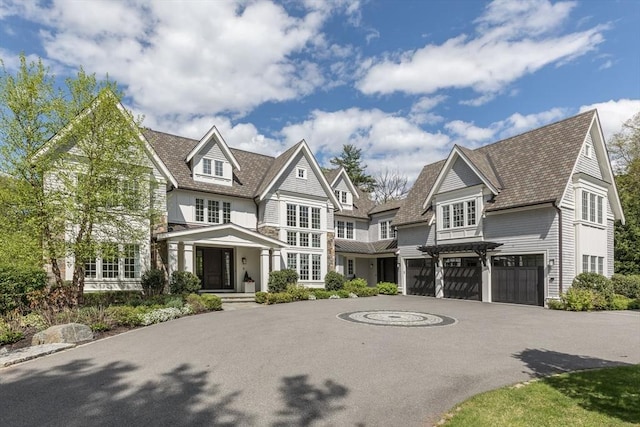 8 Hidden Rd, Weston, MA 02493 - shingle-style home with an attached garage and curved driveway