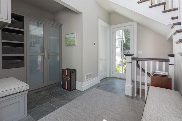 8 Hidden Rd, Weston, MA 02493 - entryway featuring baseboards, vaulted ceiling, dark stone finish flooring, and stairs