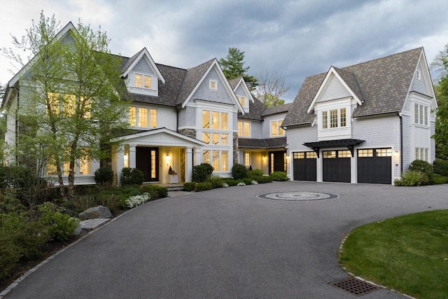 8 Hidden Rd, Weston, MA 02493 - shingle-style home featuring an attached garage, curved driveway, and stone siding