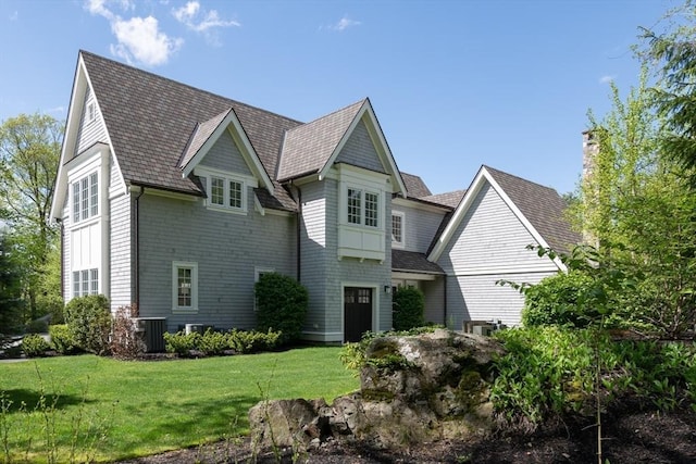 8 Hidden Rd, Weston, MA 02493 - shingle-style home with a front lawn, central air condition unit, and a chimney