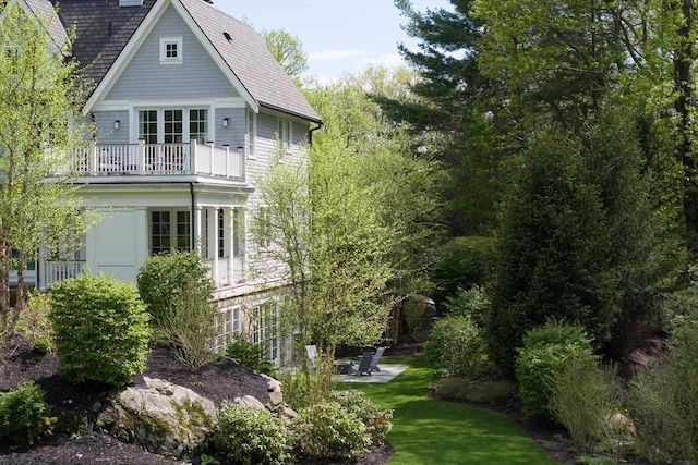 8 Hidden Rd, Weston, MA 02493 - view of side of property with a balcony, a patio, a yard, and a shingled roof