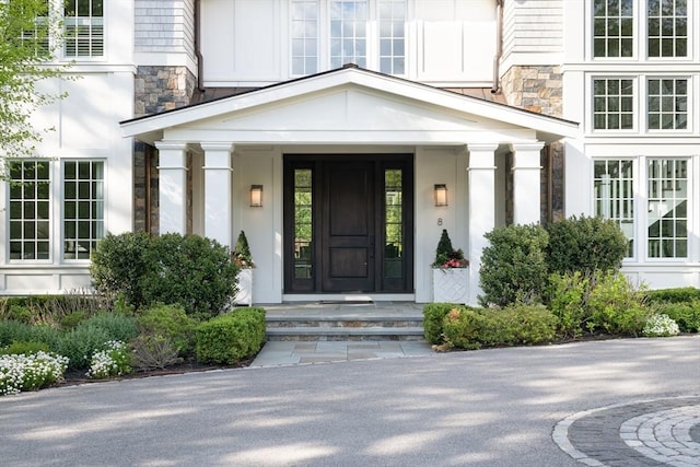 8 Hidden Rd, Weston, MA 02493 - doorway to property with stone siding and stucco siding