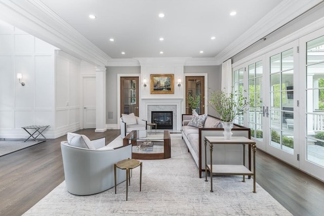 8 Hidden Rd, Weston, MA 02493 - living room featuring a fireplace, crown molding, wood finished floors, a decorative wall, and recessed lighting